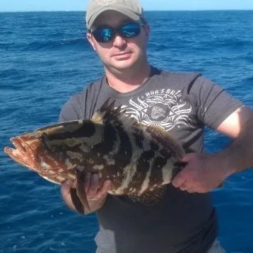 0-1 a man holding a fish in the water